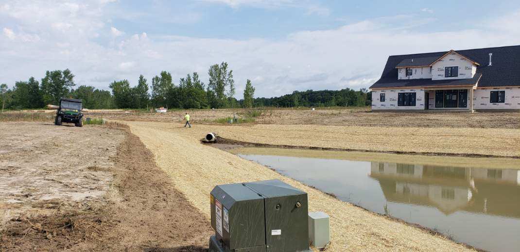 retaining pond with freshly landscaped edges retaining pond with freshly landscaped edges
